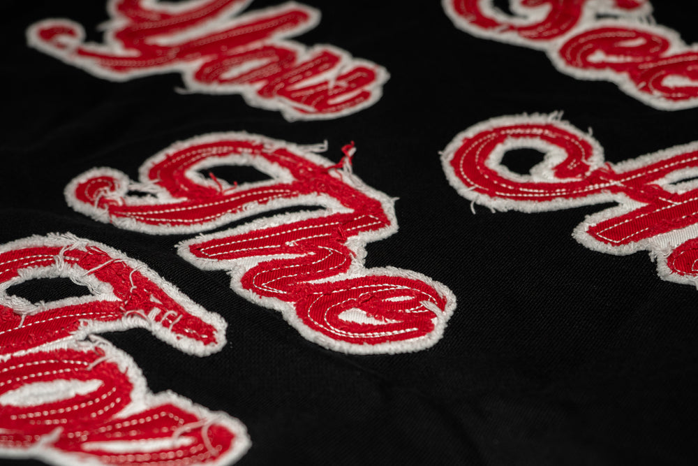 'I See You At The Top' lettering on the back, close up